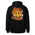Lächelnder gelber Smiley mit großen glänzenden Augen, orange karierter Strickmütze und weißen Handschuhen sitzt umgeben von orange und gelb gefärbten Ahornblättern, hält eine dampfende Kaffeetasse mit Blumenmotiv in der rechten Hand. – Unisex Heavy Blend Hoodie | Gildan 18500