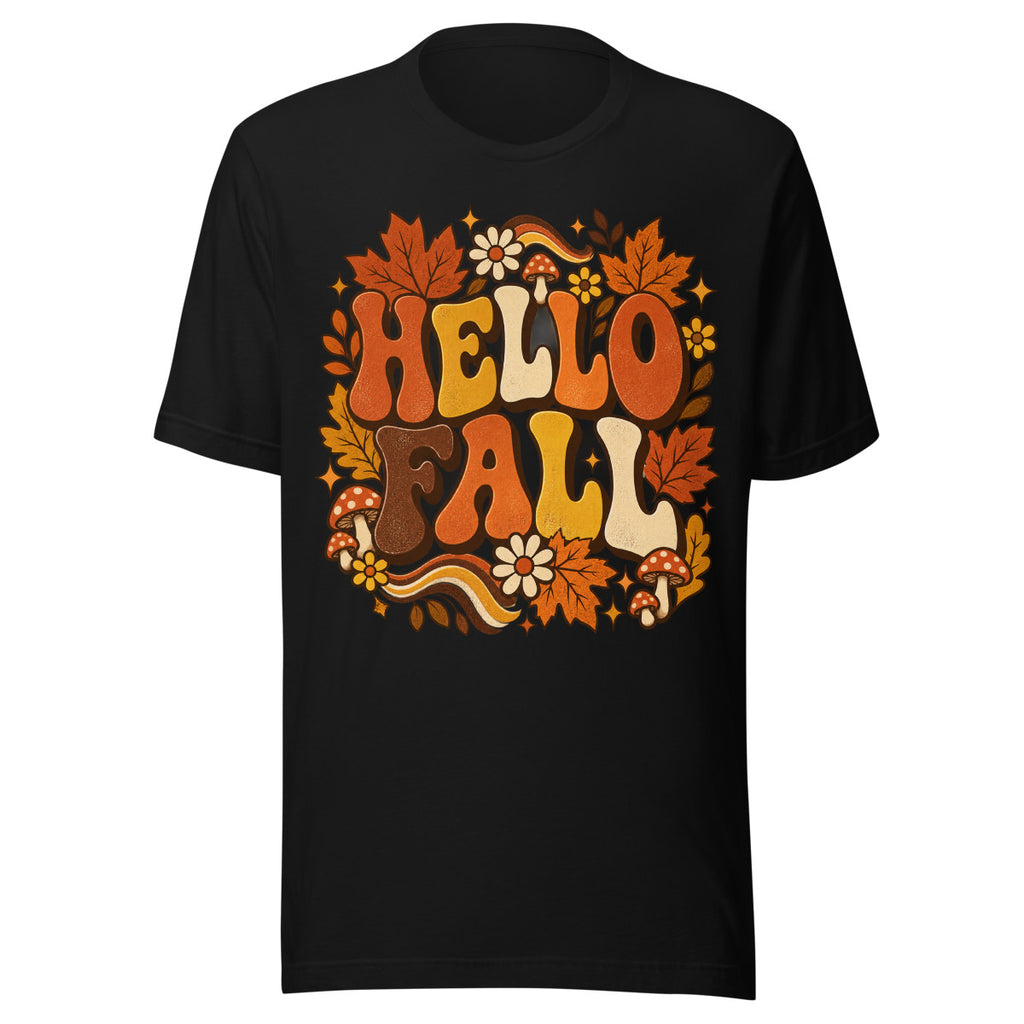 Schriftzug "HELLO FALL" in großen, bunten Buchstaben umgeben von orangefarbenen Ahornblättern, roten Fliegenpilzen mit weißen Punkten, gelben und weißen Blumen sowie dekorativen Sternen und Blättern. – Unisex Staple T-Shirt | Bella + Canvas 3001